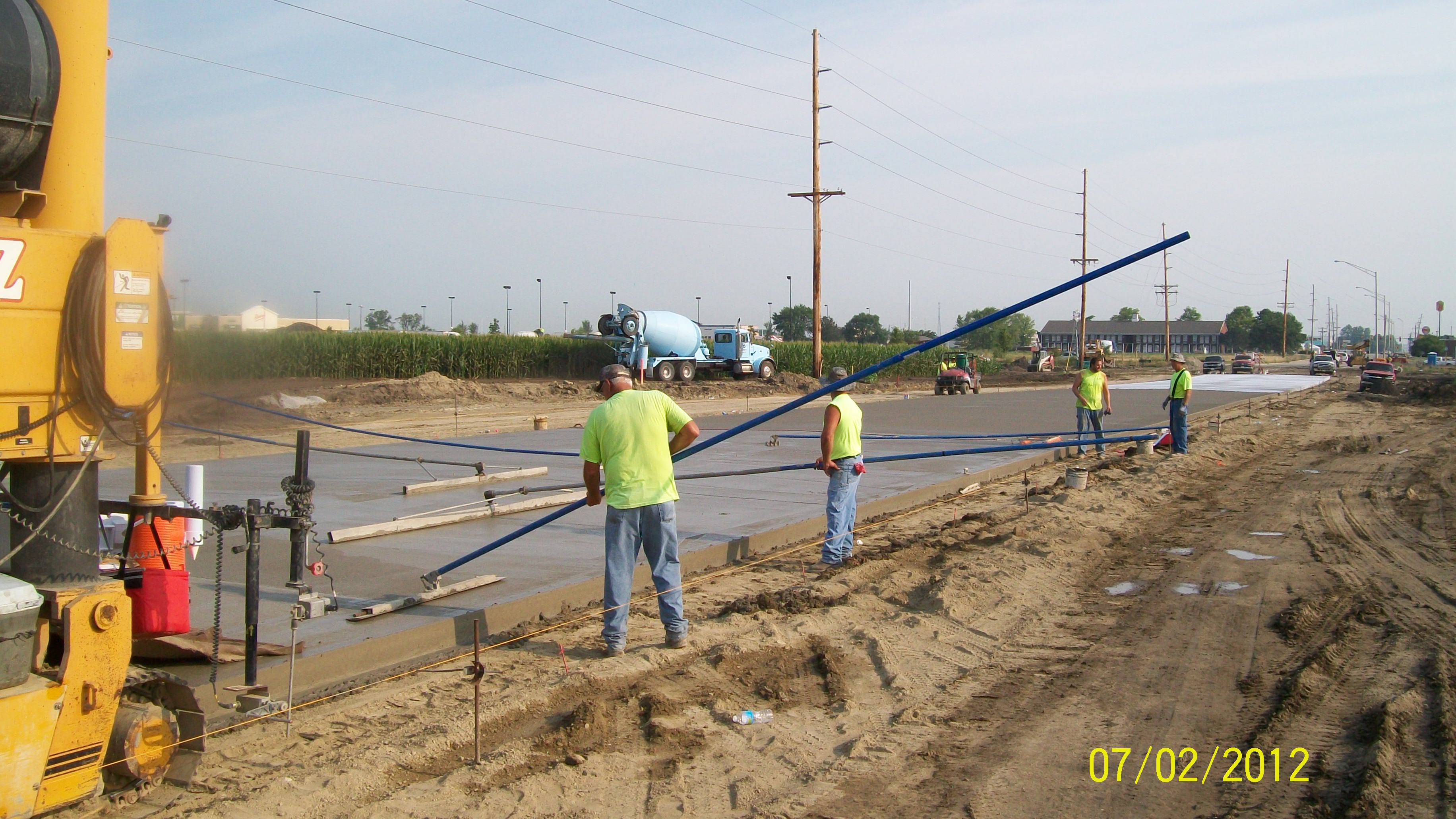 Workers smoothing the pavement on Murray Road